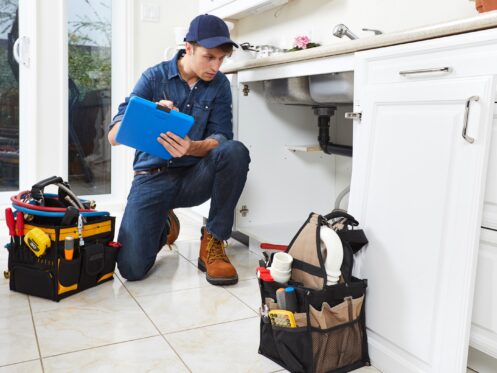 Plumber with clipboard during inspection